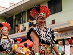 female Costa Rican parade performer smiling in a cultural costume