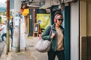 woman wearing a headset walking through the streets of San Jose